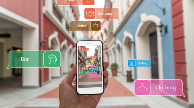 Dans la rue. Une main tient un smartphone.